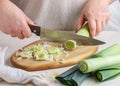 Woman sliced fresh raw leeks