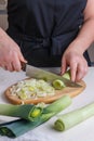 Woman sliced fresh raw leeks