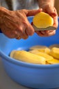 Fresh tasty potatoes cut into perfect round slices. Woman sliced potatoes in round shape with knife in a blue bowl