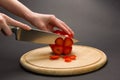 Woman slices red pepper on chopping board Royalty Free Stock Photo