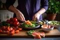 woman slicing ingredients for smoked salmon bruschetta Royalty Free Stock Photo