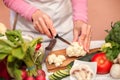 Woman slicing and preparing cauliflower