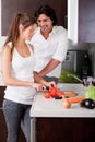 Woman slicing tomatoes with her boyfriend