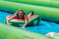 Woman Slides Down Giant Slip And Slide In Innertube Royalty Free Stock Photo