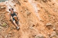 Woman Slides Down Slick Dirt Hill In Obstacle Course Race