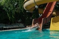 Woman slides down from the slide into the pool Royalty Free Stock Photo