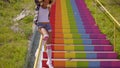 Woman Sliding Down Metallic Banisters.