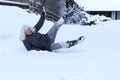 A woman slipped and fell on a snow covered road