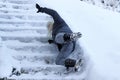 A woman slipped on the snow-covered stairs and fell