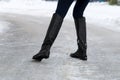 Woman slips on slippery road covered with ice. Concept of injury risk in winter.