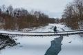 Woman on the small bridge over the frozen river in winter Royalty Free Stock Photo