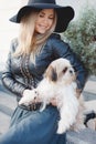 Woman with small dog in city street. Royalty Free Stock Photo