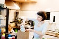 Woman small local shop owner packing shopping