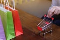 Woman and Small shopping cart with Laptop for Internet online shopping concept Royalty Free Stock Photo