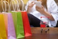 Woman and Small shopping cart with Laptop for Internet online shopping concept Royalty Free Stock Photo