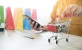 Woman and Small shopping cart with Laptop for Internet online shopping concept Royalty Free Stock Photo