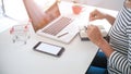 Woman and Small shopping cart with Laptop for Internet online shopping concept Royalty Free Stock Photo