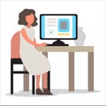 Woman in smart casual sitting at the desk and working on the computer