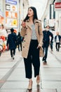 Woman in smart casual suit walking joyful