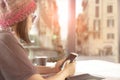 Woman and smarthphone in hand sitting in coffee ship against eur Royalty Free Stock Photo