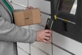 Woman with smartphone entering QR code to open shopping locker. Caption: Read the QR code here and pick it up faster. Royalty Free Stock Photo