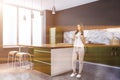 Kitchen corner, green countertops, island, woman Royalty Free Stock Photo