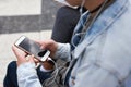 Woman, smartphone screen and earphones in city for social media, radio technology and iot internet. Female hands in