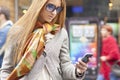 Woman with smartphone walking on street