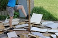 A woman smashes furniture on the floor Royalty Free Stock Photo