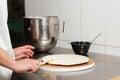 Woman smears by milk cream chocolate cakes. Process of making the chocolate cake, from begin to the end. Royalty Free Stock Photo