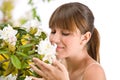 Woman smelling blossom of Rhododendron flower Royalty Free Stock Photo