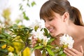 Woman smelling blossom of Rhododendron flower Royalty Free Stock Photo