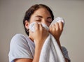 Woman smelling a clean towel after doing laundry at her home, hotel or resort while spring cleaning. Housekeeping, maid