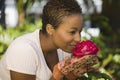 Woman Smelling Flower In Garden