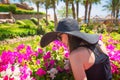 Woman smelling a flower in the park