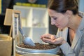 Woman smelling handful coffee grains