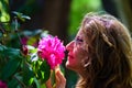 Woman smelling a large flower of intense colors in spring. Royalty Free Stock Photo