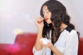 Woman smelling perfume indoors portrait