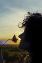 Woman smelling poppy flowers at sunset Royalty Free Stock Photo