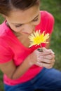 Woman smelling a yellow flower Royalty Free Stock Photo