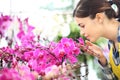 Woman smells the flowers in the garden, fragrance of orchids