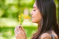 Woman smells yellow florets Royalty Free Stock Photo