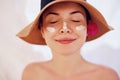 Woman smile applying sun cream on face. Skincare. Body Sun protection. sunscreen. Female in hat smear moisturizing lotion on ski