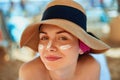 Woman smile applying sun cream on face. Skincare. Body Sun protection. sunscreen.