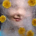 Woman smile  through  ice with dandelions flowers Royalty Free Stock Photo