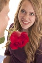 Woman smile man rose in mouth Royalty Free Stock Photo