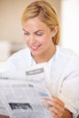 Woman, smile and newspaper for reading in home for knowledge, information and world news. Female person, happy and face Royalty Free Stock Photo