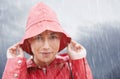 Woman, smile and portrait with rain, coat and clouds with happiness in nature. Person, face and storm with cloudy Royalty Free Stock Photo