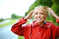 Woman, smile and raincoat or hands in storm, wet and cold from weather, winter and nature. Happy female person, fashion Royalty Free Stock Photo