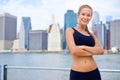 Woman and smile at river side with city view on sport clothes to jog, fitness and healthy mindset in New York. Portrait Royalty Free Stock Photo